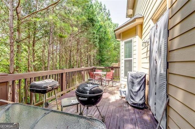 wooden terrace featuring a grill