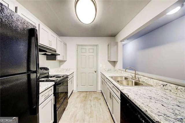 kitchen featuring sink, light hardwood / wood-style floors, white cabinetry, and black appliances