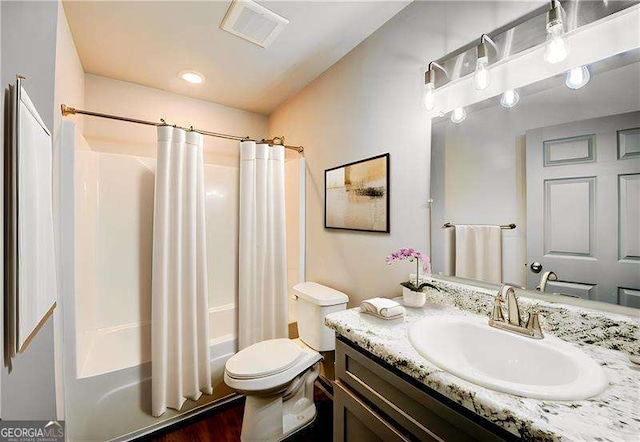 full bathroom featuring vanity, shower / bathtub combination with curtain, and toilet