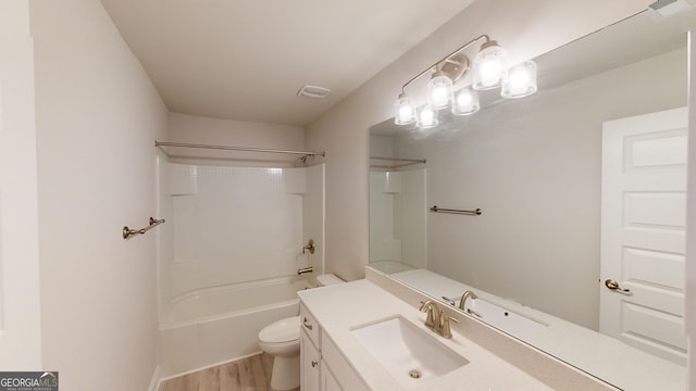 full bathroom with bathing tub / shower combination, vanity, wood-type flooring, and toilet