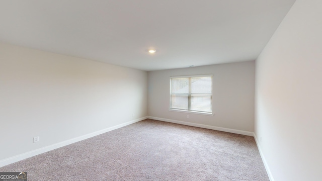 unfurnished room featuring carpet