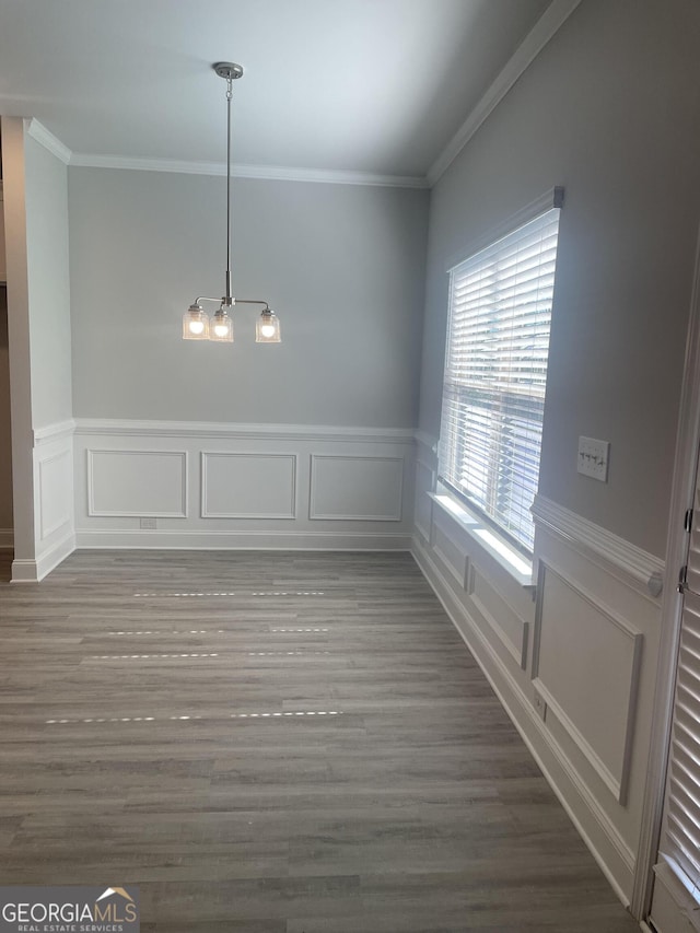 unfurnished dining area with wood-type flooring and ornamental molding