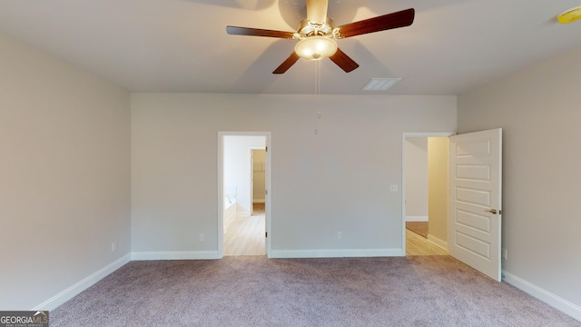 unfurnished room featuring light colored carpet and ceiling fan