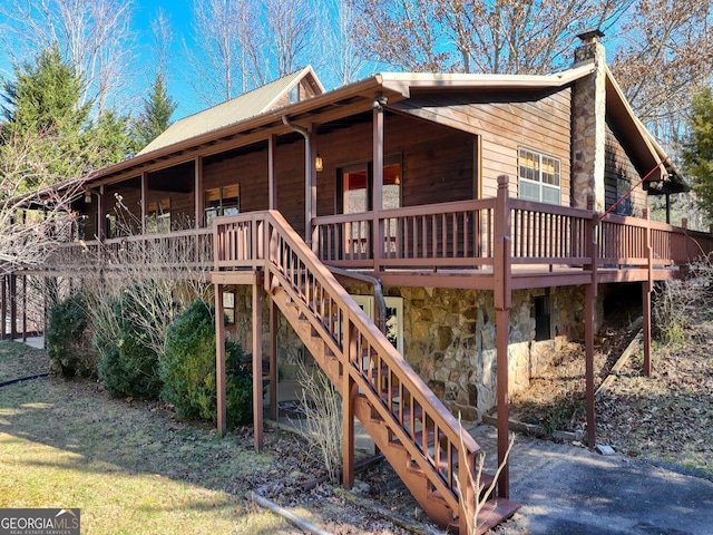 rear view of property with a wooden deck