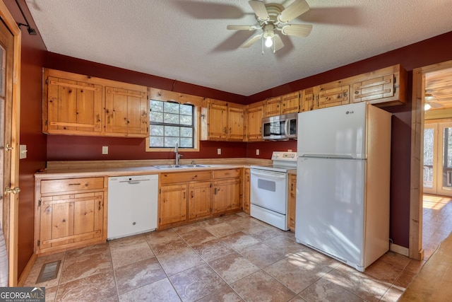 kitchen featuring a textured ceiling, ceiling fan, white appliances, and sink