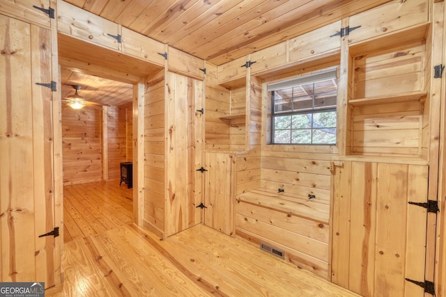 corridor with wooden walls, wood-type flooring, and wooden ceiling