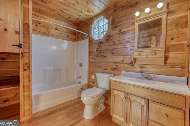 full bathroom featuring wood ceiling, bathtub / shower combination, vanity, toilet, and wood walls