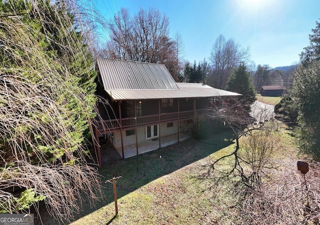 back of house featuring a yard and a patio area