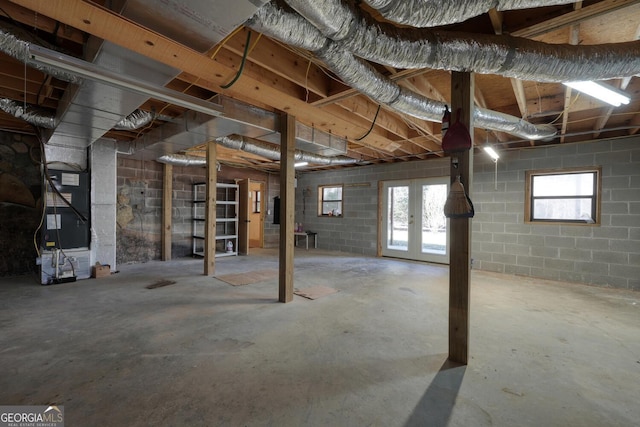 basement featuring heating unit and french doors