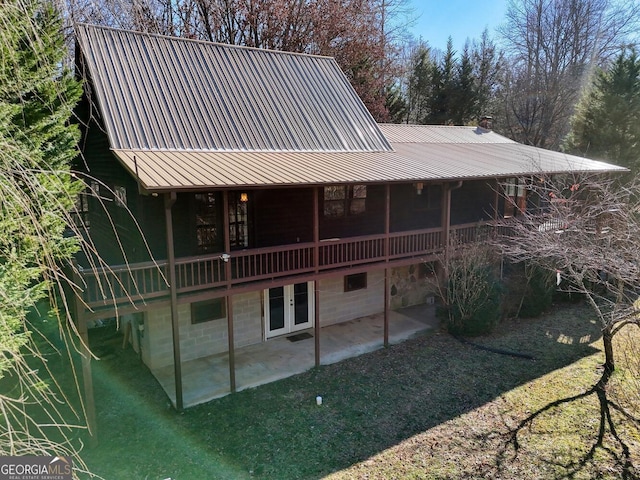 back of house with a patio area and a yard