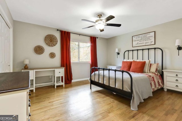 bedroom featuring ceiling fan, light hardwood / wood-style floors, and a closet