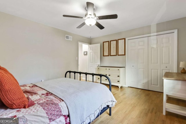 bedroom featuring ceiling fan, a closet, and light hardwood / wood-style floors