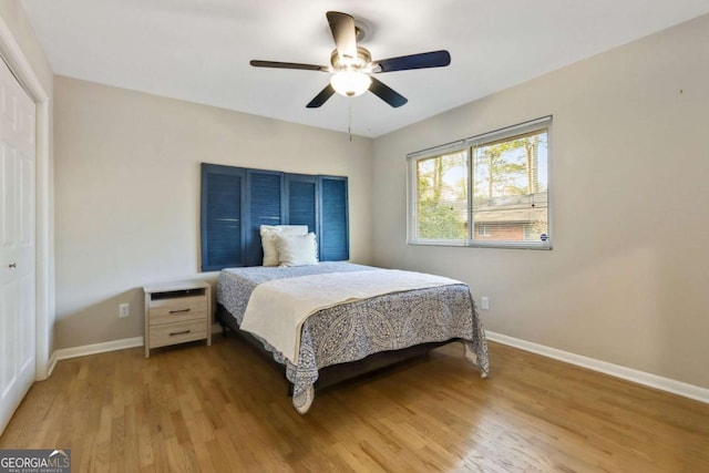 bedroom featuring ceiling fan, a closet, and light wood-type flooring