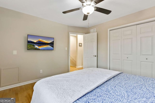 bedroom featuring ceiling fan, a closet, and hardwood / wood-style floors