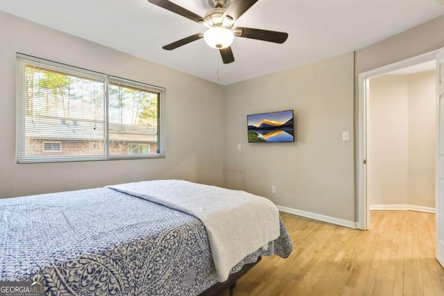 bedroom with ceiling fan and light hardwood / wood-style floors