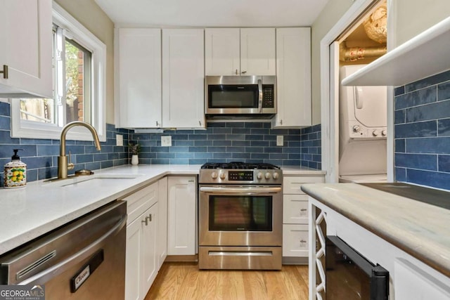 kitchen featuring white cabinets and appliances with stainless steel finishes