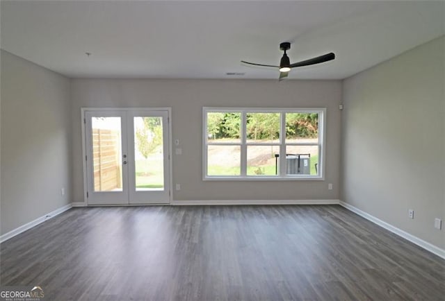 unfurnished room with ceiling fan, dark wood-type flooring, and french doors