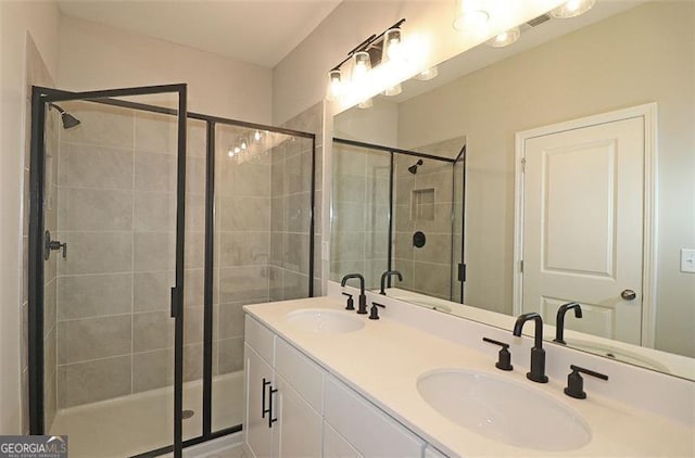 bathroom featuring vanity and a shower with door