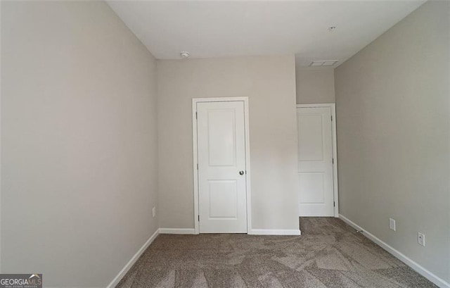 unfurnished bedroom featuring light colored carpet