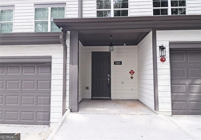 view of exterior entry featuring a garage