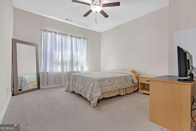 bedroom with ceiling fan and light colored carpet