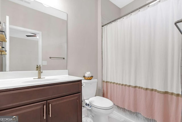 bathroom with vanity, toilet, and ceiling fan