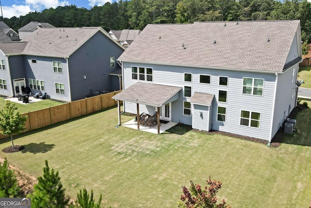 back of house featuring a patio area and a yard