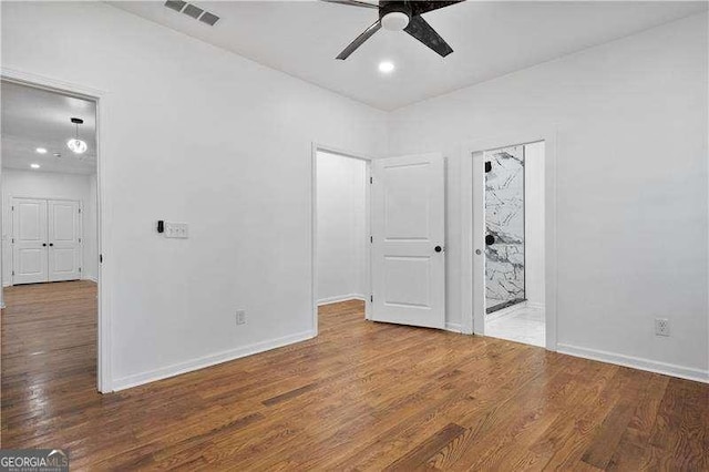 spare room featuring hardwood / wood-style floors and ceiling fan