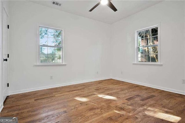 spare room with ceiling fan and wood-type flooring