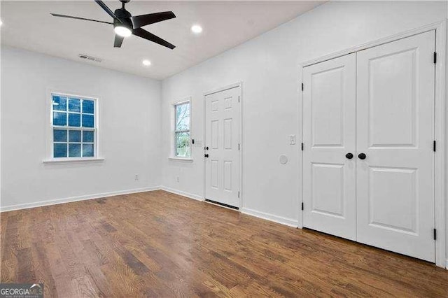 foyer entrance with dark hardwood / wood-style floors and ceiling fan