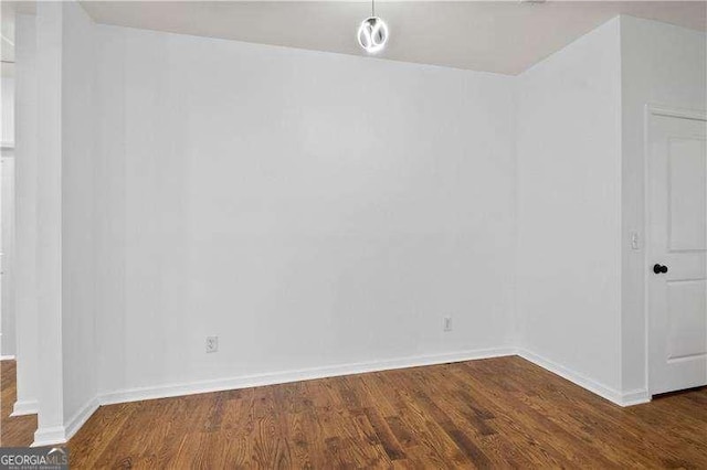 empty room featuring dark hardwood / wood-style flooring