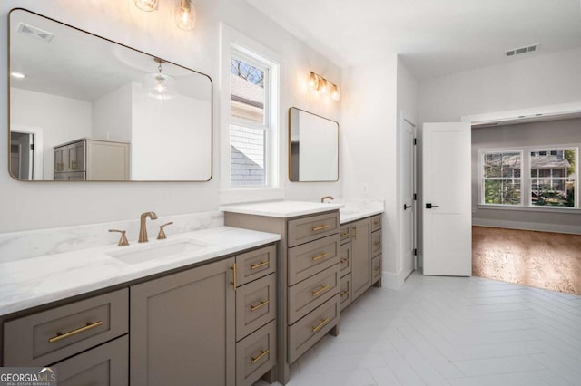 bathroom with vanity and a wealth of natural light