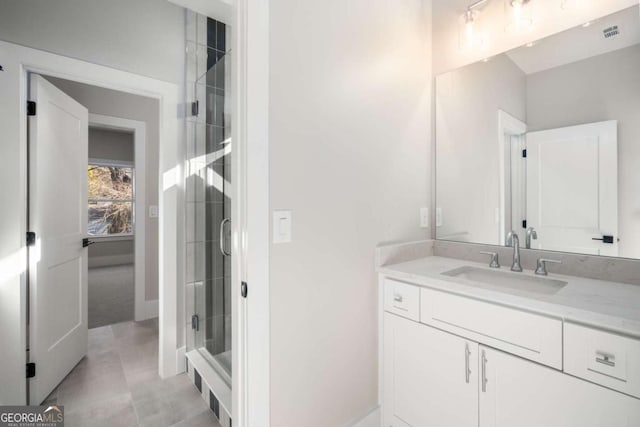 bathroom featuring vanity and an enclosed shower