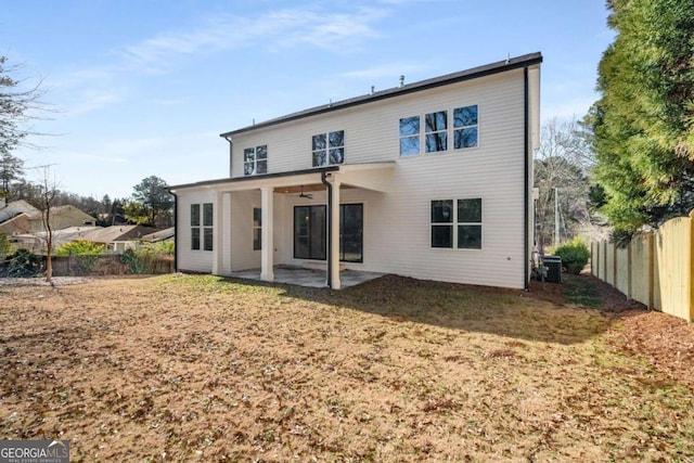 rear view of property featuring a patio, a yard, ceiling fan, and central air condition unit