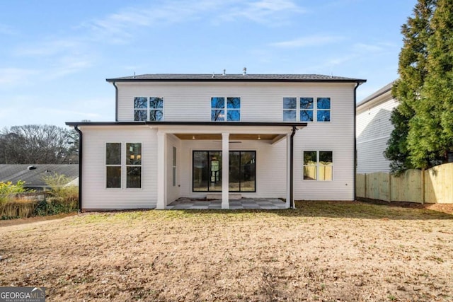 back of property with a patio and a lawn