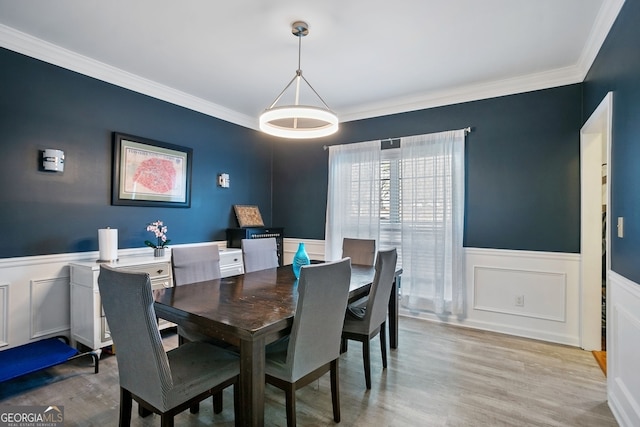 dining room featuring crown molding and light wood-type flooring