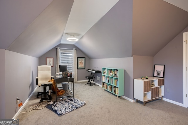 carpeted office space featuring vaulted ceiling