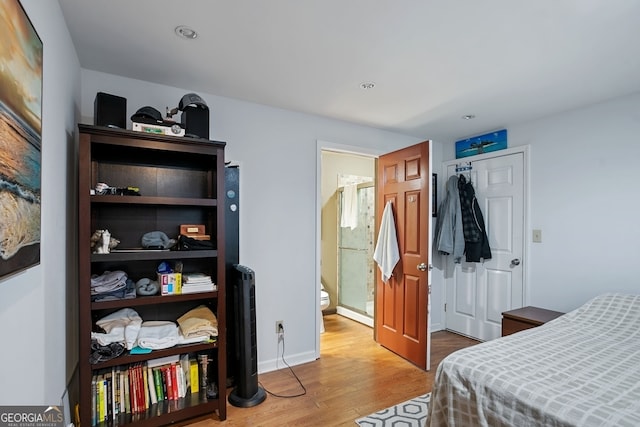 bedroom featuring wood-type flooring and a closet