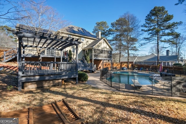 view of pool featuring a pergola, a sunroom, a yard, and a deck