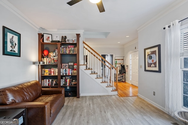 sitting room featuring a healthy amount of sunlight, light wood-type flooring, ceiling fan, and crown molding