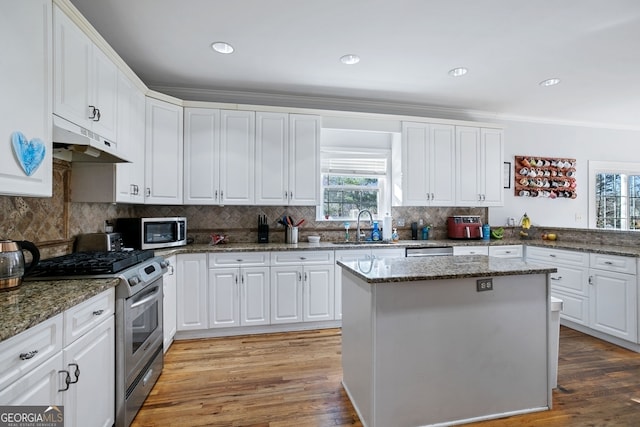 kitchen featuring dark stone countertops, sink, white cabinets, and stainless steel appliances