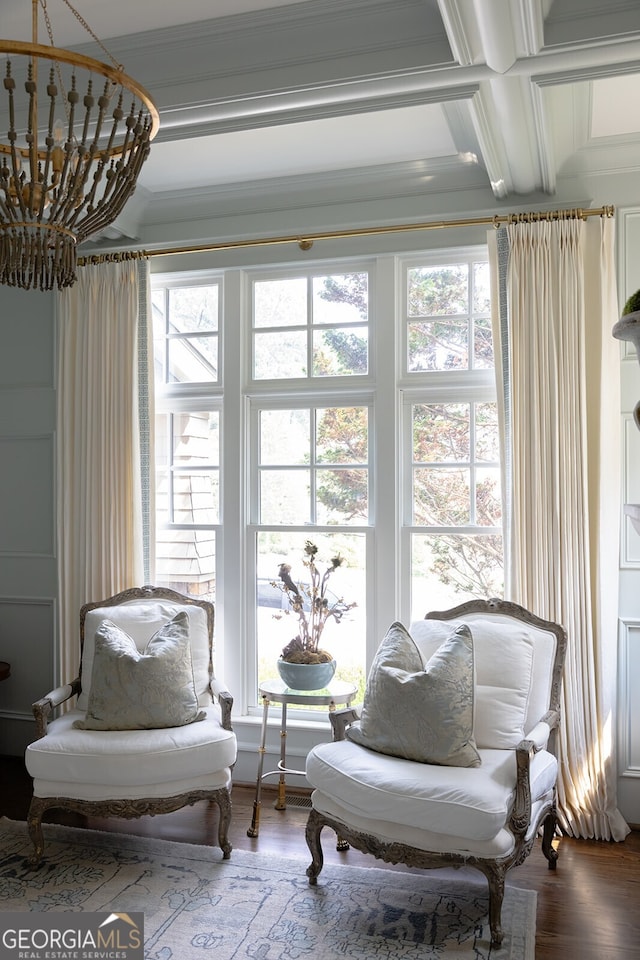 sitting room featuring hardwood / wood-style flooring, coffered ceiling, a notable chandelier, crown molding, and beam ceiling