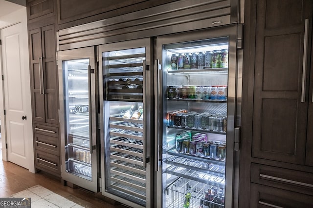 entryway with beverage cooler and light wood-type flooring