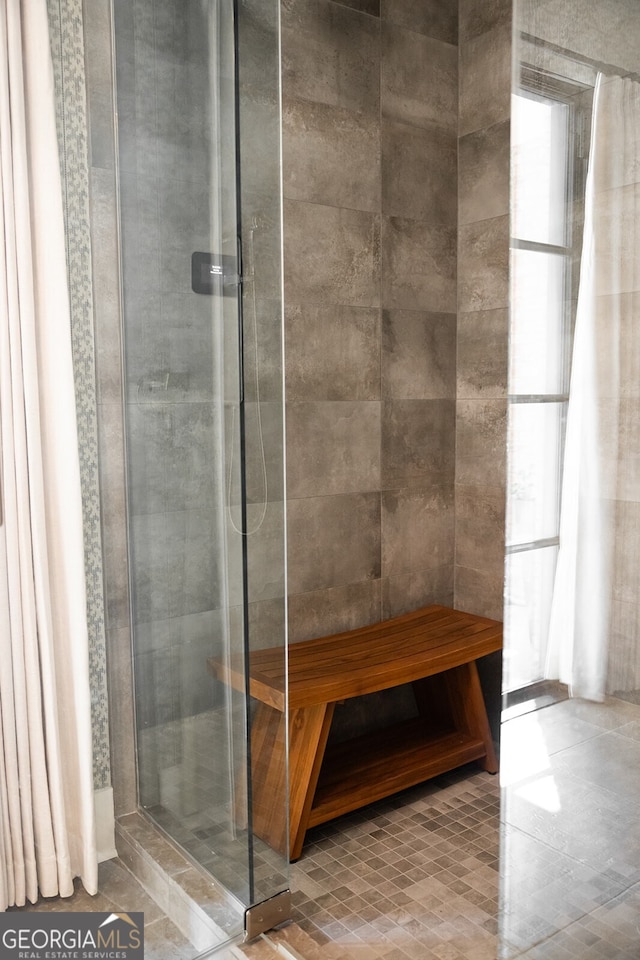 bathroom with tiled shower