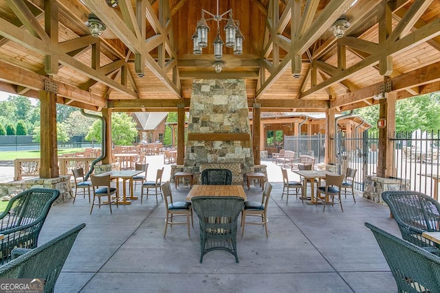 view of patio featuring a gazebo and an outdoor stone fireplace