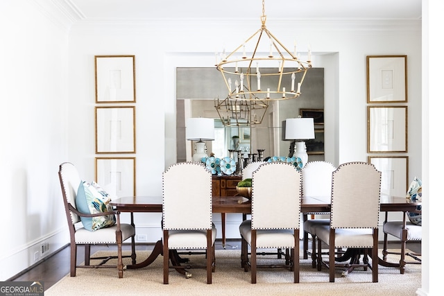 dining space featuring ornamental molding and a chandelier