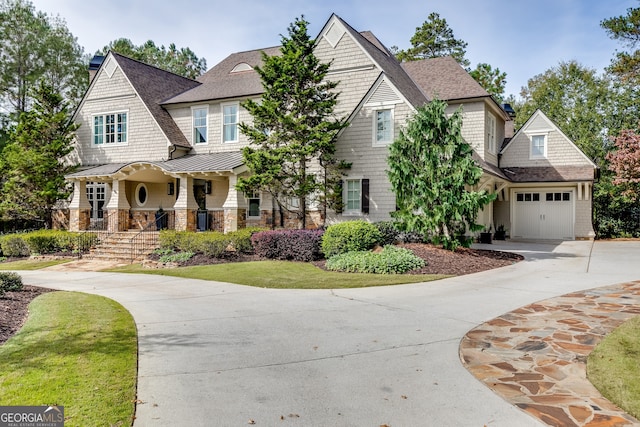 craftsman inspired home featuring a porch and a garage