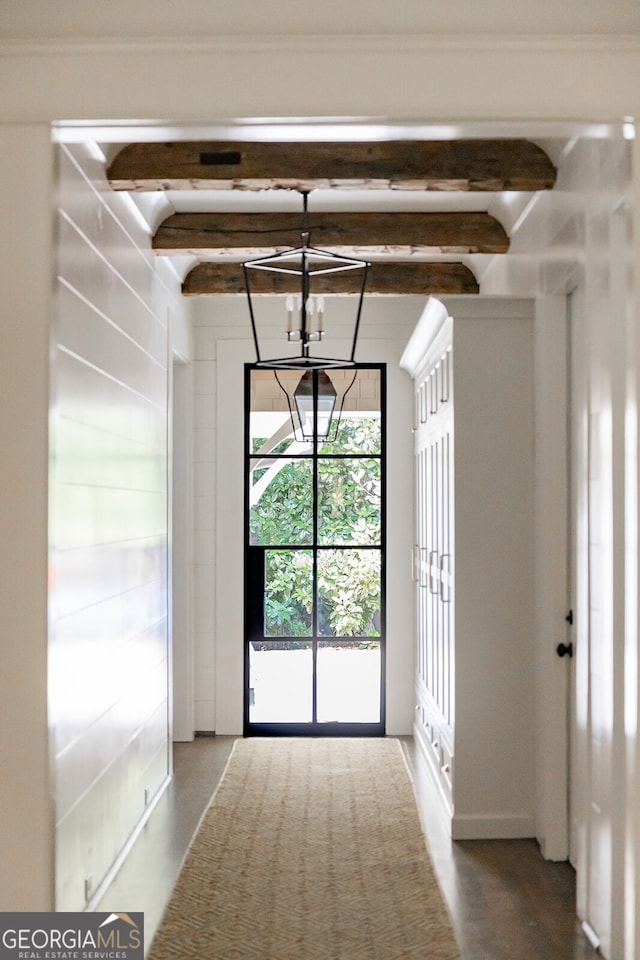 interior space featuring a chandelier and beamed ceiling