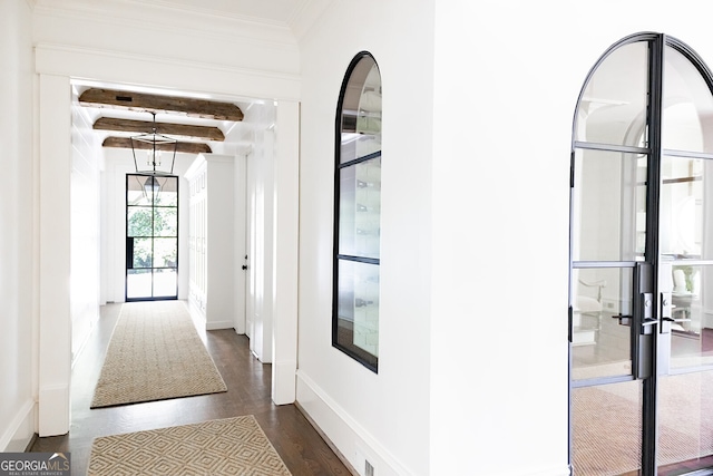 hallway with dark hardwood / wood-style floors, beamed ceiling, and french doors