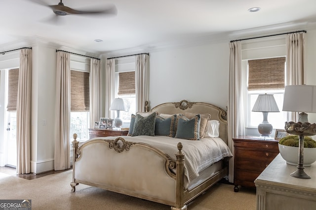 bedroom with multiple windows, crown molding, and ceiling fan